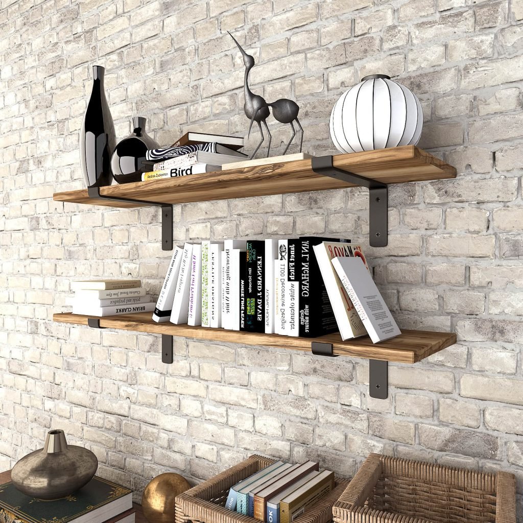 Black heavy duty L-shaped steel shelf brackets supporting wooden shelves on a brick wall